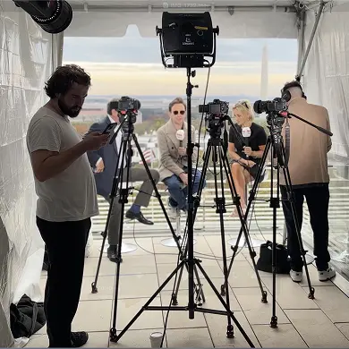 Outdoor interview setup with cameras and crew.